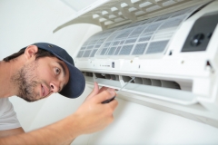 Man working on air conditioning unit